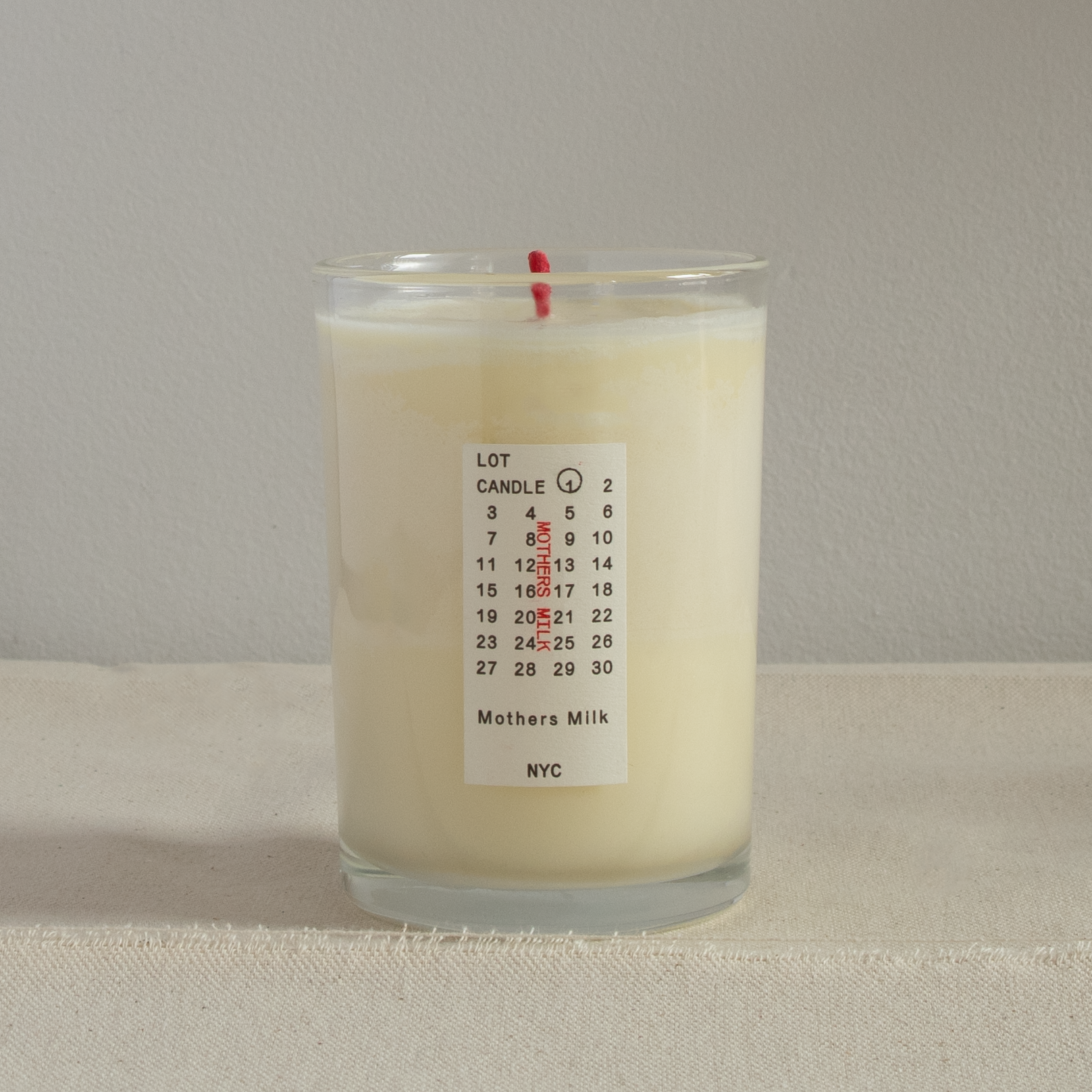 7.5oz candle in a glass vessel with a red wick